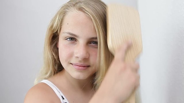 little girl brushing her hairs