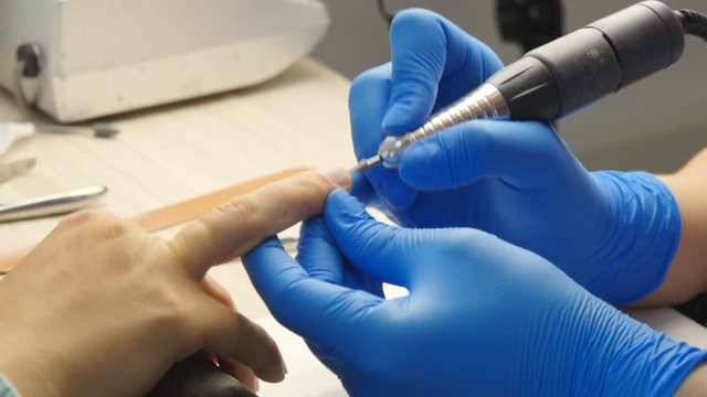 Manicure. The device removes the cuticle