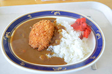 Japanese popular curry rice with deep fried pork cutlet and slightly sweet mix of pickles
