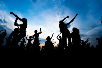 Fototapeta na wymiar silhouettes of young people dancing