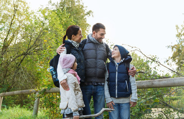 happy family with backpacks hiking