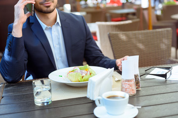 Business man communicating on phone in cafe