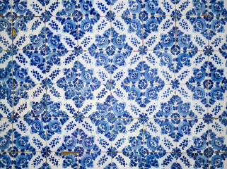 A piece of an old blue floral ceramic tile in Portugal on the wa
