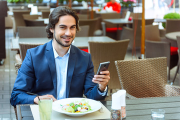 Happy businessman resting in restaurant