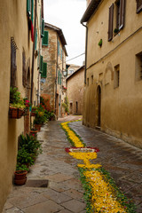 Street in the old town of Pienza, in Italy, decorated with flowers