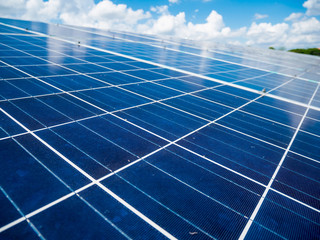 Solar panels with blue sky and clouds