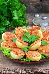 Baked potatoes with ham, cheese, bread crumbs and egg.