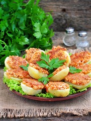Baked potatoes with ham, cheese, bread crumbs and egg.
