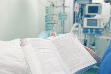 Fototapeta premium Reading medical book in patient ward