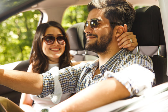 Portrait Of Young Couple Driving A Car.