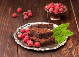 Chocolate cake brownies and raspberries