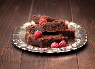 Pieces of chocolate cake brownies on a silver plate