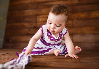 Cute little girl on a wooden background.