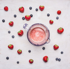 fresh ingredients for smoothies   and electric blender on white wooden background, top view ....