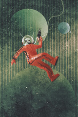 Naklejka premium space man,astronaut in red suit holding a gun against the planet earth background