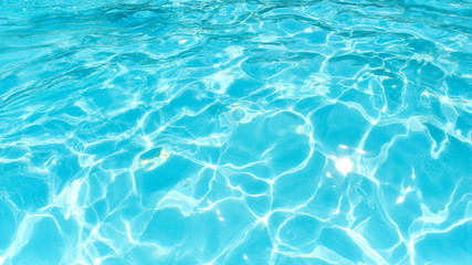 Fototapeta na wymiar Beautiful water surface in swimming pool with sun reflection