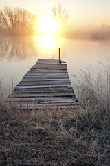 Fototapeta na wymiar Sunrise in fog with dock