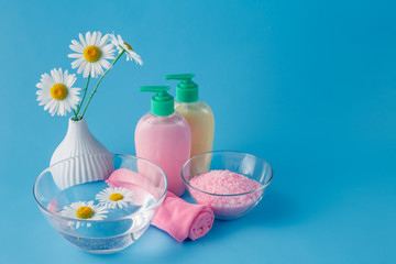 Beautiful spa setting with daisy on blue table close-up