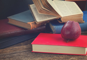 Bookshelf with books and apple