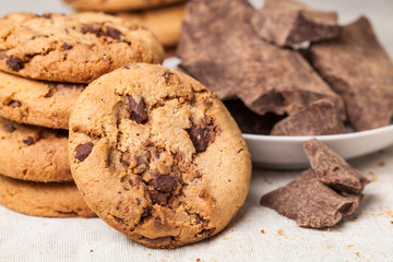 Chocolate chip cookies with chocolate parts on wooden table