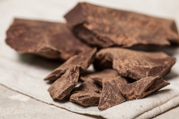 Crushed dark chocolate on old wooden table