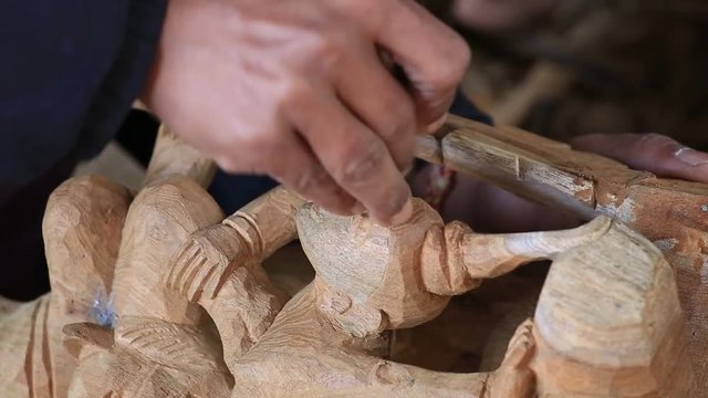 Burmese man are making wooden souvenirs for tourists. Wood Carving is a traditional handicraft in Myanmar