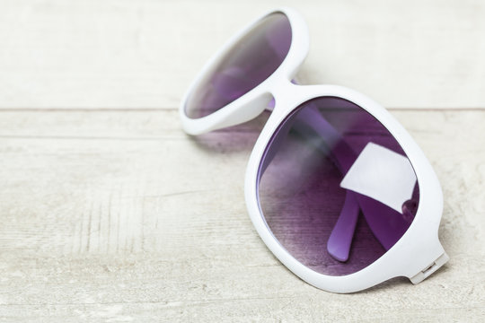 fashion sunglasses on wooden table