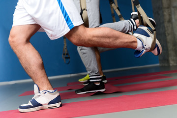 Strong sportsmen exercising in gym