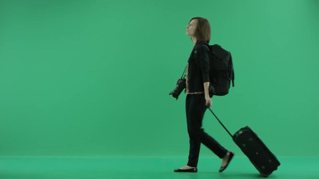 female tourist with camera walks looking around