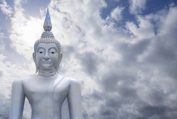 Fototapeta na wymiar abstract merge layer of sky on image of Buddha skin with blue sky and cloud in background, light effect added ,filtered image,copy space , prachuapkhirikhan,thailand