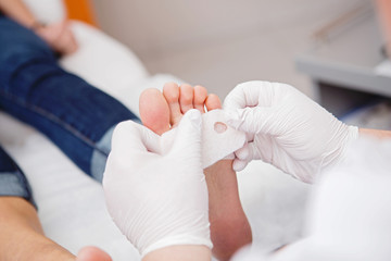 podiatrist ( chiropodist ) cleaning womans feet