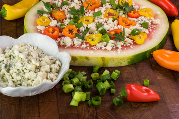 Vegetarian watermelon pizza with crumbled blue cheese, bell peppers and parsley.