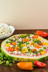 Fototapeta na wymiar Vegetarian watermelon pizza with crumbled blue cheese, bell peppers and parsley.