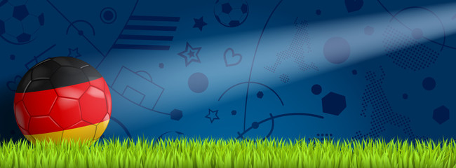 Deutschland Ball vor blauem Hintergrund auf Rasen © HeGraDe