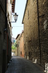 Narrow alley in San Marino under blue sky