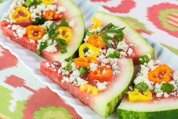 Pieces of vegetarian watermelon pizza with crumbled blue cheese,