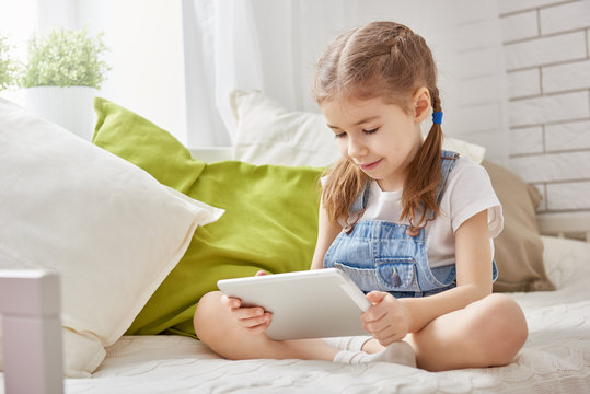 girl playing in tablet computer