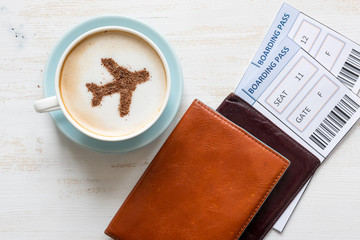 Boarding passes, passports and coffee with aircraft made of cinnamon