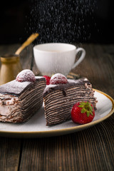 Chocolate cake with strawberries and cup of coffee