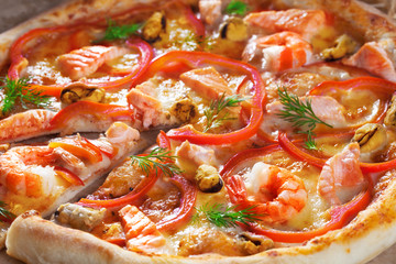 Pizza with salmon mussels, shrimp dill, close-up, sweet pepper