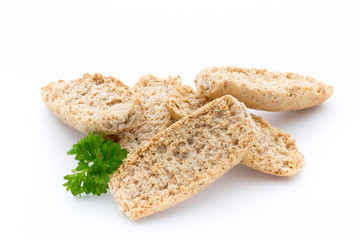 Dry flat bread crisps with herbs on a white background.