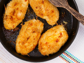 Chicken Breasts Stuffed with Cheese and Ham in Pan. View from above