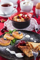 Breakfast with pancakes, cheesecakes and porridge