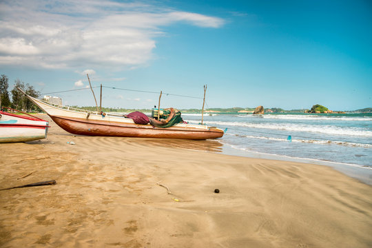 WELIGAMA, SRI LANKA fishermen boats near the ocean.