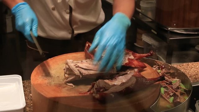Chef prepares peking roast duck in a restaurant in Siam Paragon Mall. Bangkok, Thailand. With 300,000 sq m of retail space Siam Paragon is one of the world's largest malls