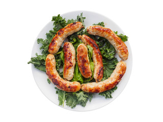 Homemade sausages on the plate with kale
