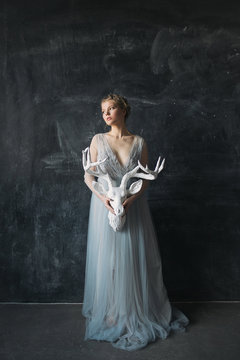 Young beautiful bride in wedding dress posing in studio