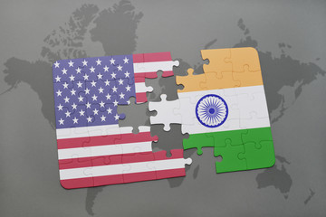 puzzle with the national flag of united states of america and india on a world map background
