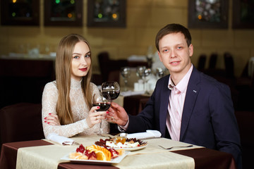 Couple toasting wineglasses in a luxury restaurant.
