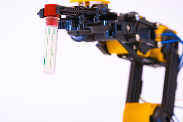 Plastic model of industrial robotics arm  Robot manipulator with sample test tube